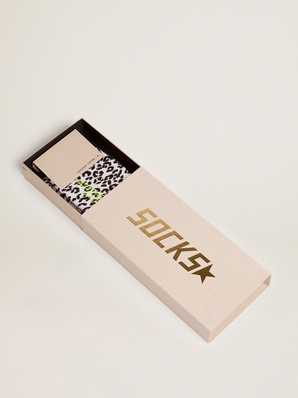 Black and white socks with leopard print and black star on the back| Golden Goose