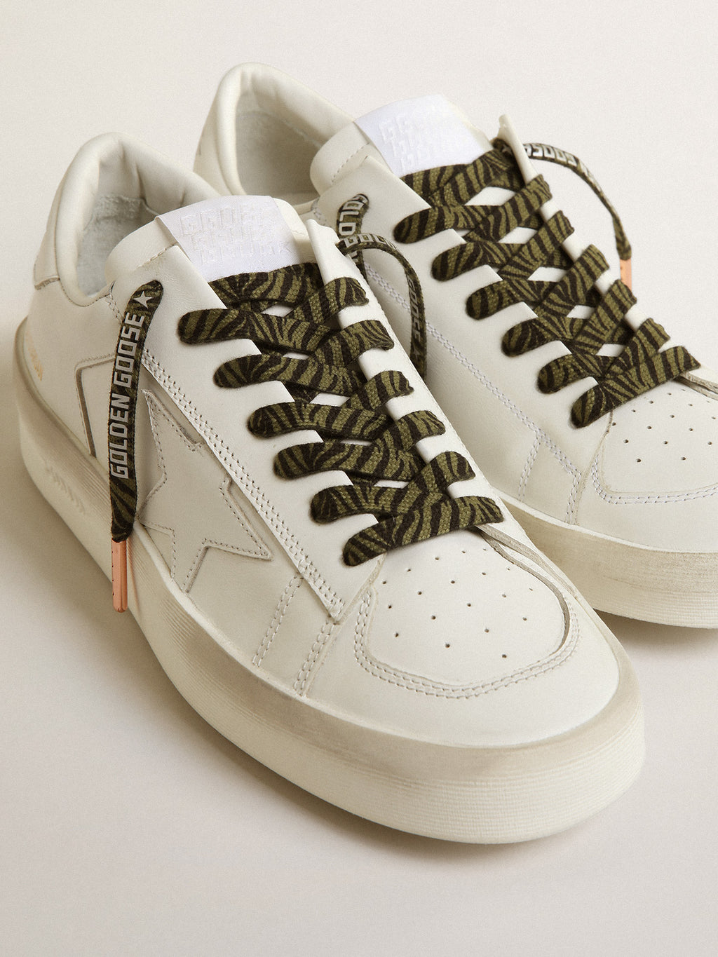 Green and black zebra-print laces with contrasting silver-colored logo| Golden Goose