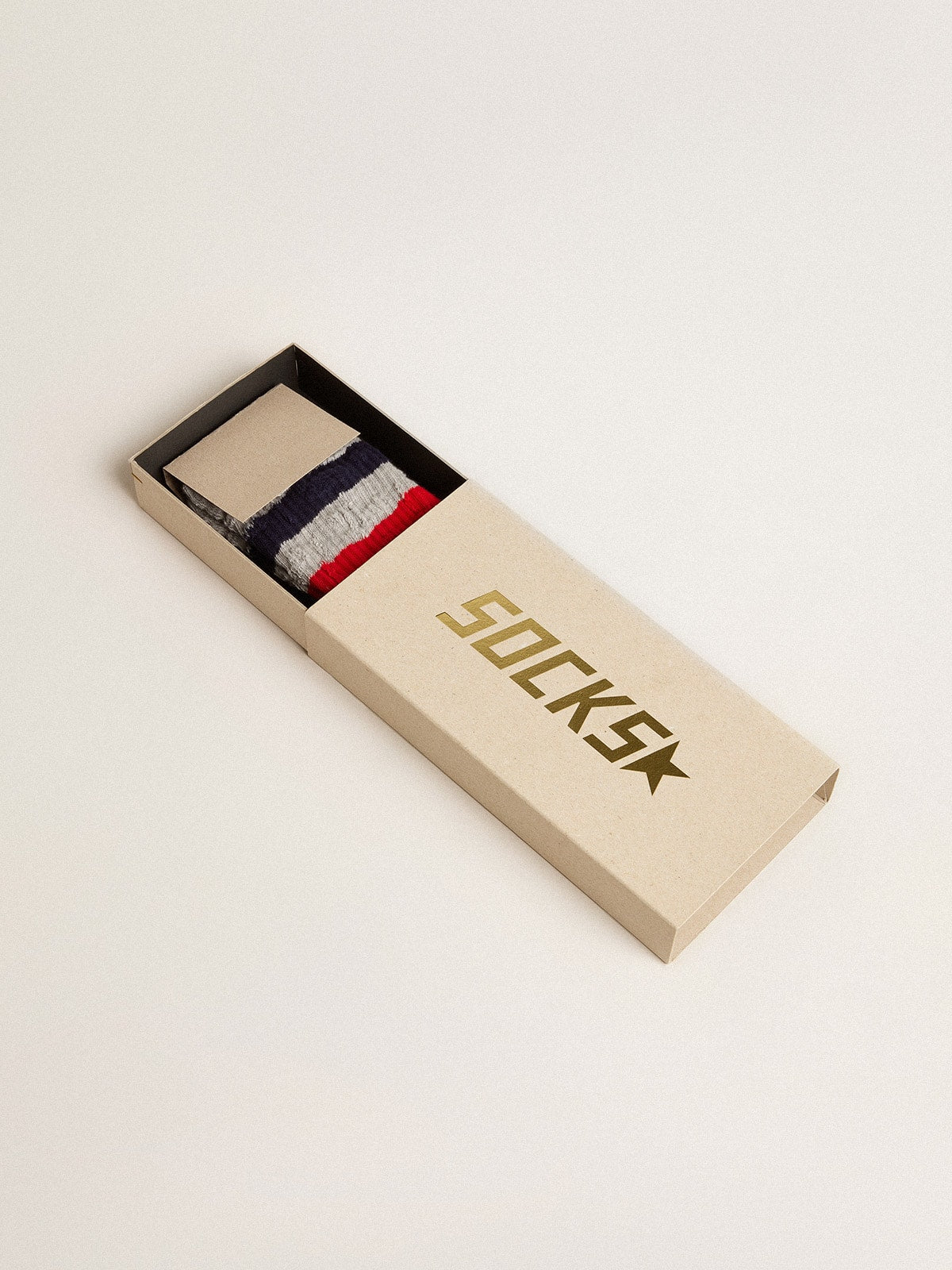 Gray socks with contrasting red and blue stripes and red logo
