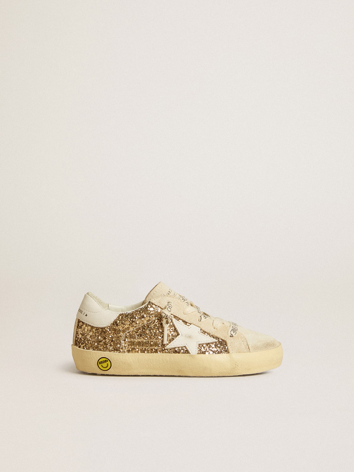 Super-Star Young in gold glitter with white leather star and heel tab| Golden Goose