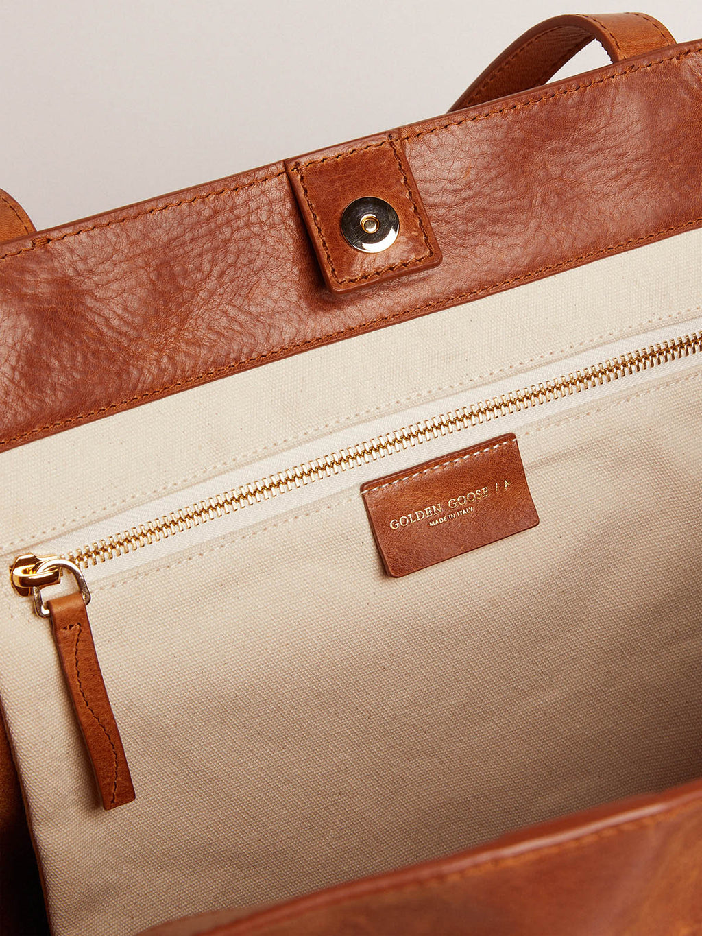 Pasadena Bag in tan-colored glossy leather with gold logo on the front| Golden Goose
