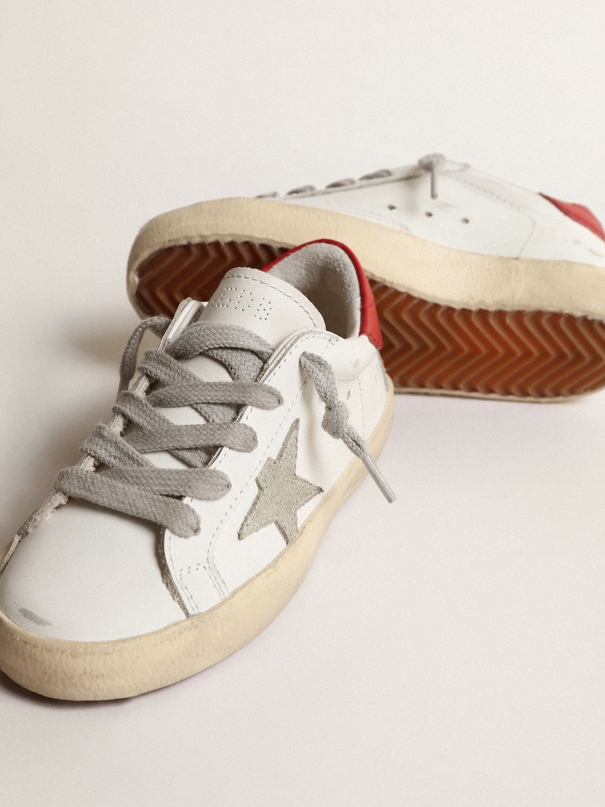 Super-Star Junior with suede star and red leather heel tab| Golden Goose
