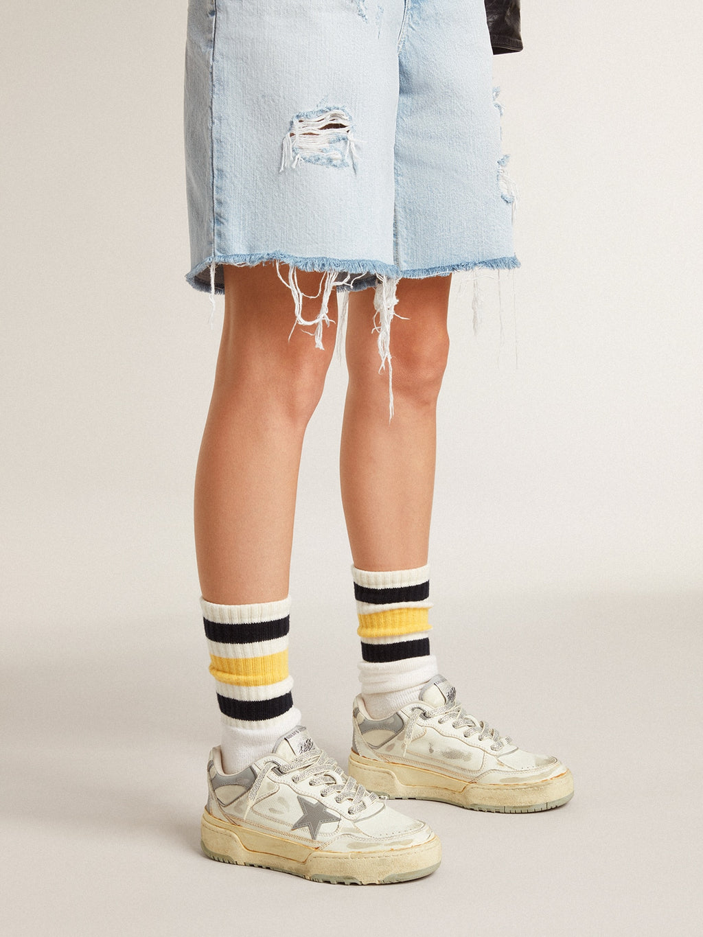 Worn-white socks with distressed details and black and yellow stripes| Golden Goose